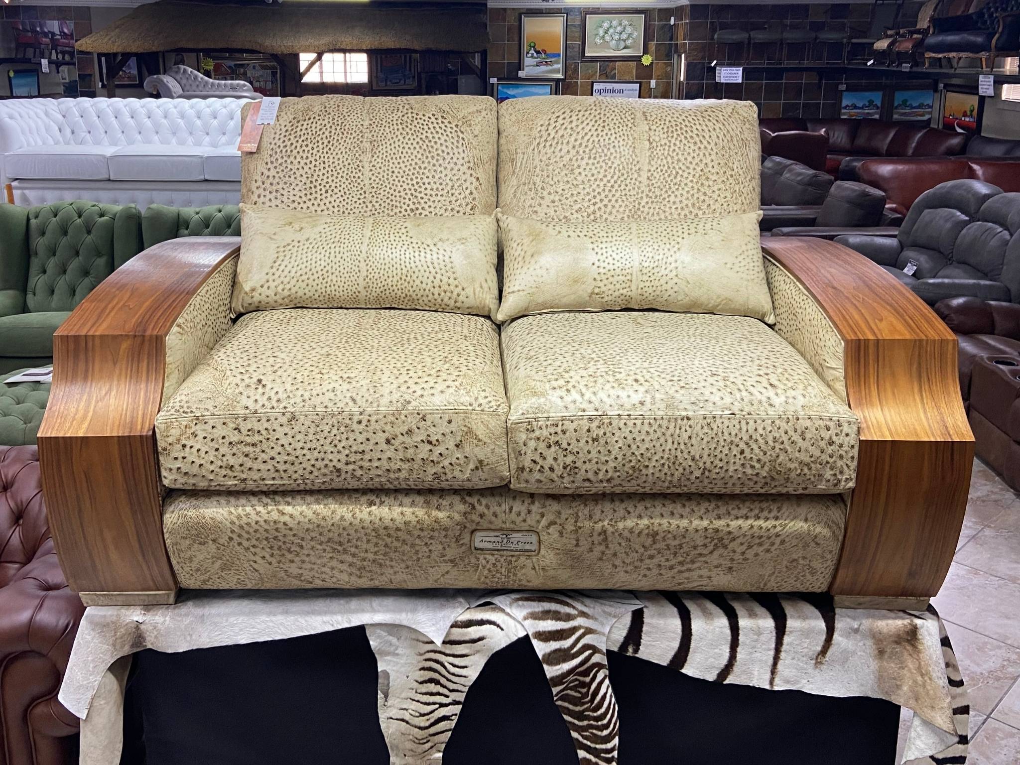 Front view of genuine ostrich leather sofa with walnut arms